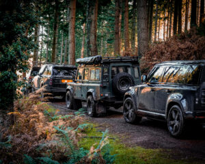 Rear view of custom Defender in the forest on shoot day