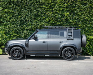 Side view of the new Defender with air intake, roof rack and ladder